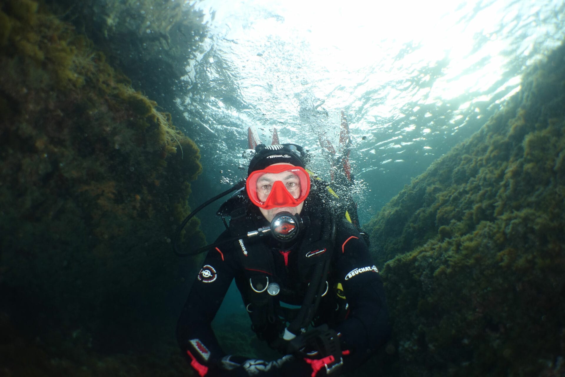 A scuba diver wearing water equipment
